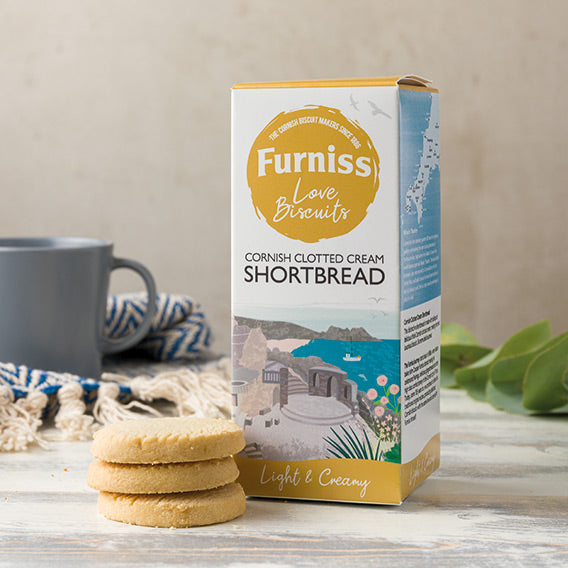 Furniss Cornish Clotted Cream Shortbread box with cookies and a mug on a wooden surface