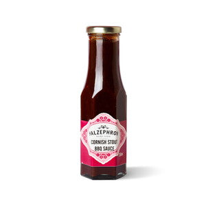 Bottle of Halzephron Cornish Stout with a pink label on a white background