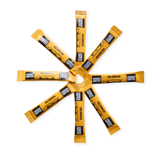 Yellow coffee sticks with 'Cornish Coffee' branding arranged in a circular pattern on a white background.