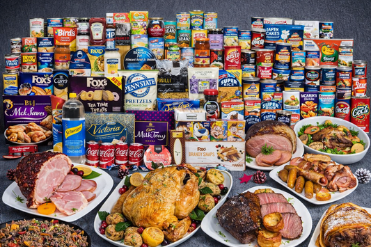 Assorted food products including meats, cakes, and beverages on a dark background
